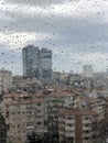 Rain drops on window pane against city view Royalty Free Stock Photo