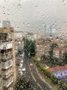 Rain Drops On A Window Pane Against City View