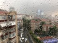 Rain drops on a window pane against city view Royalty Free Stock Photo