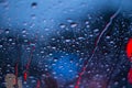 Rain drops on window with road light bokeh, rainy season.