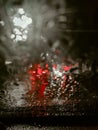 Rain drops on window with road light bokeh, water drop on the glass, night storm raining car driving concept. Night car Royalty Free Stock Photo