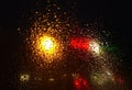 Rain drops on window with road light bokeh,water drop on the glass, night storm raining car driving concept. night car Royalty Free Stock Photo