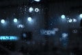 Rain drops on window with street bokeh lights Royalty Free Stock Photo