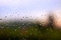 Rain drops on window with sunset behind Royalty Free Stock Photo