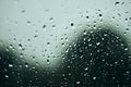 Rain drops on window, with trees and leaves outside Royalty Free Stock Photo