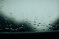 Rain drops on window, with trees and leaves outside Royalty Free Stock Photo