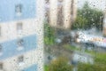 rain drops on windowpane and blurred city