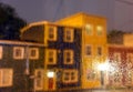 Rain drops on windows with jellybean houses at night in Newfoundland