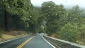 Rain drops on windscreen, car driving in Yosemite forest, Road trip, California. Royalty Free Stock Photo
