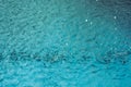 Rain fall on the pool in rains season. Close up of blue water waves, low angle view. Selective focus. Background texture Royalty Free Stock Photo