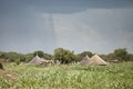 Rain falling near huts in south Sudan