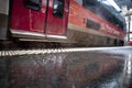 Rain falling on the station platform in front of a train Royalty Free Stock Photo