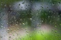 Rain falls on a green background in blur. Blurred background glass window Royalty Free Stock Photo