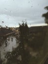 A rain falls through a window in a rainy afternoon