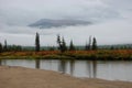 Rain, fog and low clouds on the mountain river. Royalty Free Stock Photo