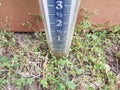 rain gauge in the ground or lawn or yard with measurement markings Royalty Free Stock Photo