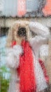 Rain. Girl photographed themselves with camera in street mirror with rain drops. Woman with camera Royalty Free Stock Photo