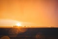 Rain in golden hour. Orange sunset and rain falling from the sky