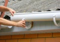 Rain gutter installation. Repair and renovate rain gutter pipeline on old house with asbestos rooftop Royalty Free Stock Photo