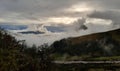 after the rain in the high mountains. the sun breaks the clouds and fogs
