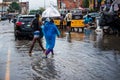 After the rain in Lagos - Two ladies walk on a flooded road