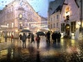 Rain in medieval city street people with umbrella walk on road crossing buildings urban lifestile rainy season weather forecast