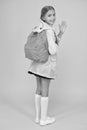 Rain is not hindrance. Schoolgirl raincoat going to school waving hand. Waterproof fabric for your comfort. Rainproof Royalty Free Stock Photo