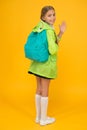 Rain is not hindrance. Schoolgirl raincoat going to school waving hand. Waterproof fabric for your comfort. Rainproof Royalty Free Stock Photo