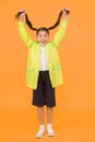 Rain is not hindrance. small girl have fun in raincoat. active schoolgirl waterproof cloak. water resistant clothes. in