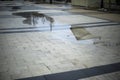 Rain outside. Puddle in square. City in rain Royalty Free Stock Photo