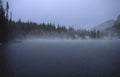 Rain over alpine lake in Rocky Mountains Royalty Free Stock Photo