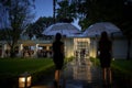 Rain pouring at wedding day event, problems with weather, umbrellas