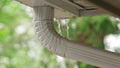 Rain Pours Off a Roof and Overflows a Rain gutter eavestrough system exceeding capacity