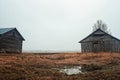 Two Old Barn Houses On The Rainy Fields