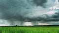 4K Rain Rainy Clouds Above Countryside Rural Field Landscape With Young Green Wheat Sprouts In Spring Summer Cloudy Day Royalty Free Stock Photo