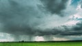 4K Rain Rainy Clouds Above Countryside Rural Field Landscape With Young Green Wheat Sprouts In Spring Summer Cloudy Day Royalty Free Stock Photo