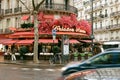 After rain scenery of Parisian street with restaurant decorated with flowers