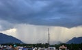 Rain shower falling from dark cumulus clouds