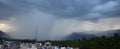 Rain shower falling from dark cumulus clouds