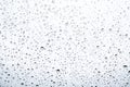 Of rain standing on a glass. water droplets on glass with white background