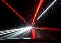 Rain Streaked Windshield at Night with Passing Car Lights Creating Dynamic Motion Blur and Royalty Free Stock Photo