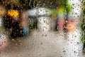 Rain water drop on glass window in rainy day with blurred bokeh background Royalty Free Stock Photo