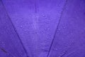 Rain water drop on purple umbrella background with copy space Royalty Free Stock Photo