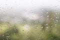 Rain water droplets on glass window with scenic greenery view Royalty Free Stock Photo