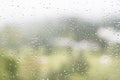 Rain water droplets on glass window with scenic greenery view Royalty Free Stock Photo