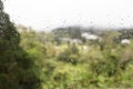 Rain water droplets on glass window with scenic greenery view Royalty Free Stock Photo