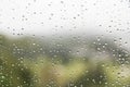 Rain water droplets on glass window with scenic greenery view Royalty Free Stock Photo