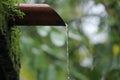 Water dropping from orange pipe Royalty Free Stock Photo