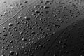 Rain or water drops different size on a black shiny car hood surface. Water droplets on dark iron surface and texture Royalty Free Stock Photo