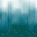 Rain water drops flow down blue background Royalty Free Stock Photo